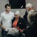 man in white dress shirt standing beside woman in black dress